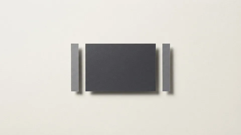 A dark paper preview panel with two thin grey paper bars standing apart on either side of it, ready to be assembled